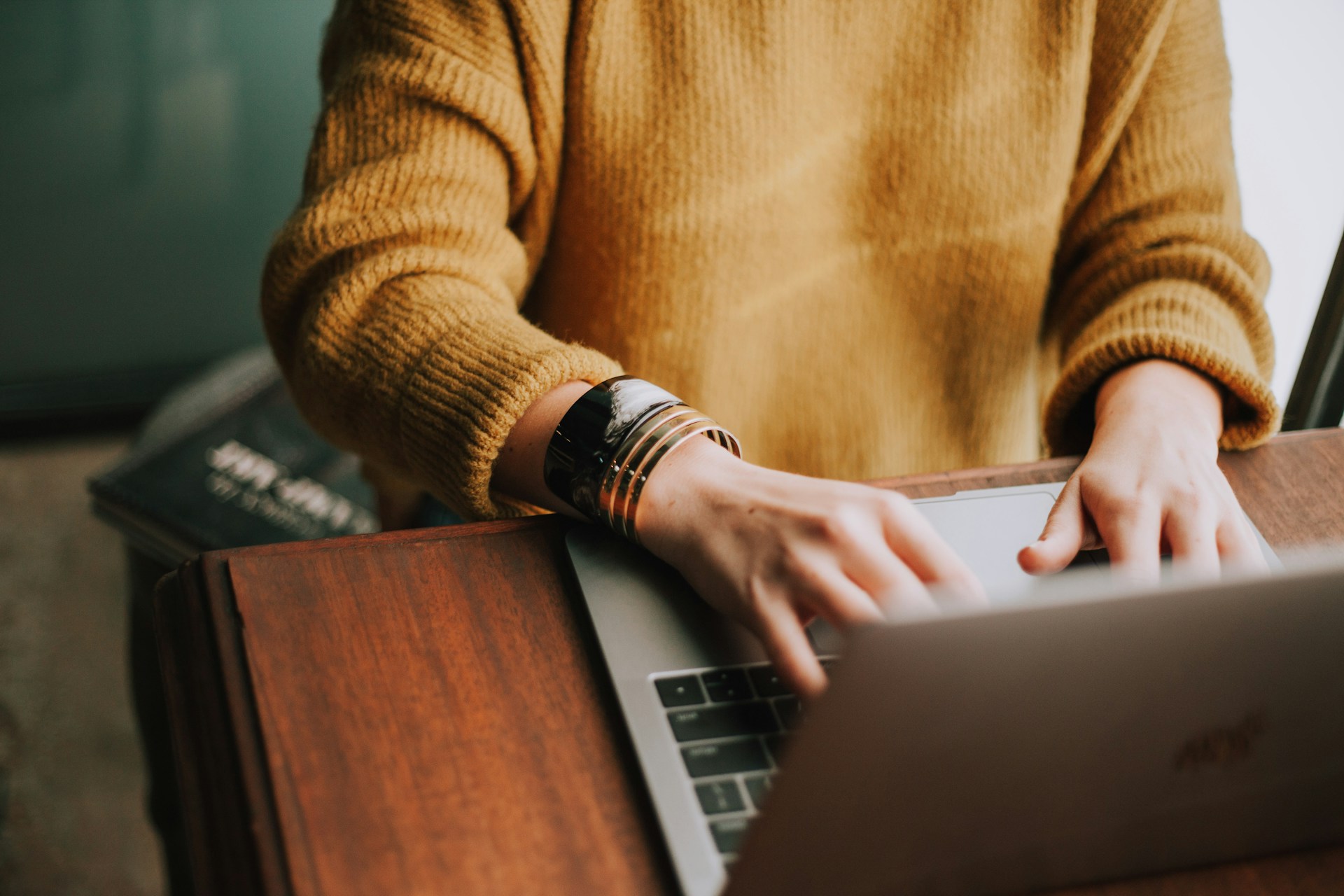 Two people working remotely on laptops during a virtual onboarding session